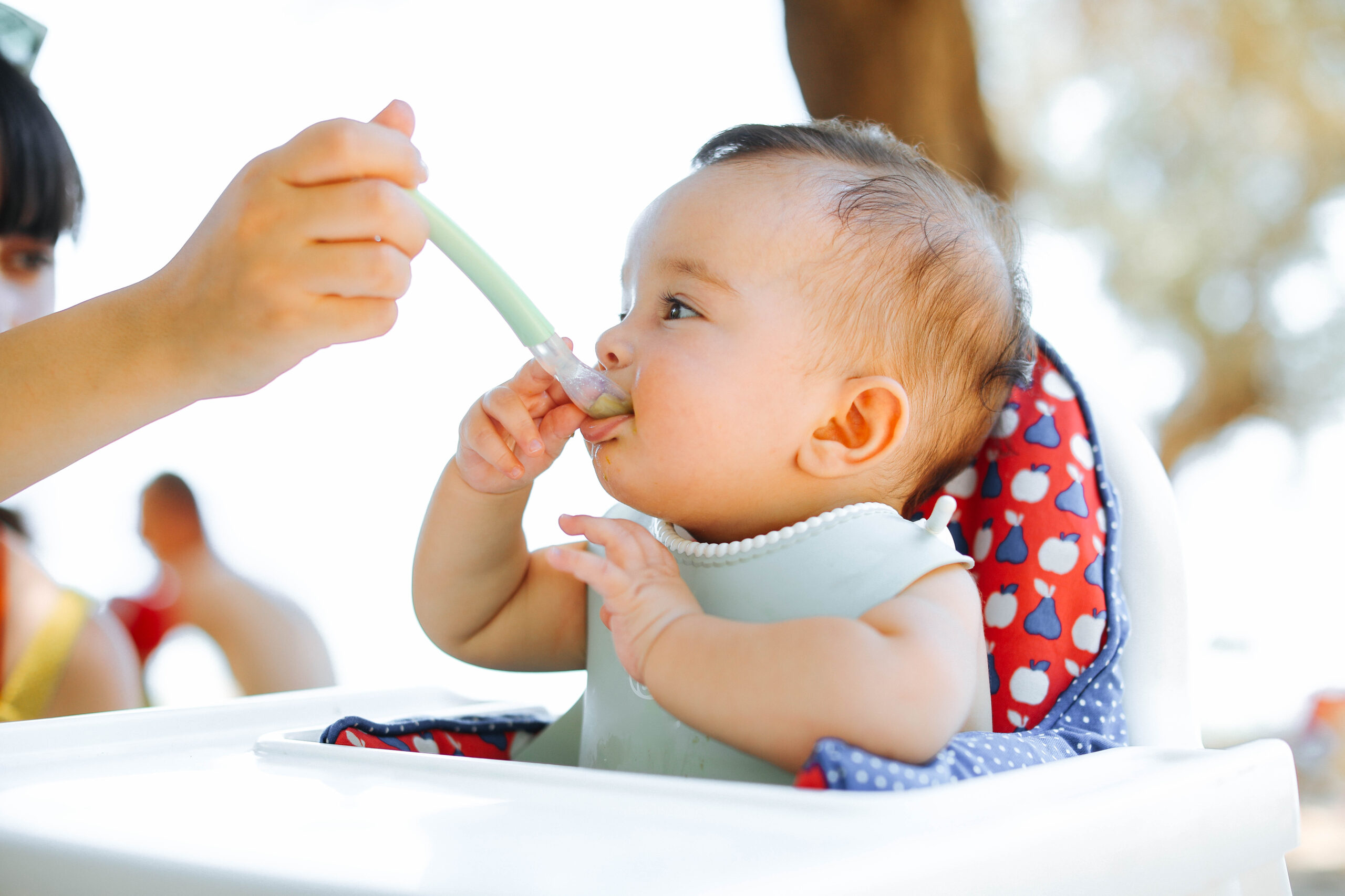 Adult feeding baby